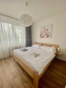 a bedroom with a large bed with white sheets at Prázdninový dům Holubka in Nové Město na Moravě