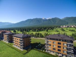 an aerial view of a building with mountains in the background at Cornelia Deluxe Residence in Bansko