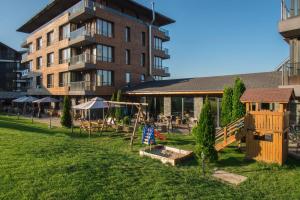 a playground in front of a large building at Cornelia Deluxe Residence in Bansko
