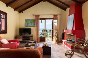 a living room with a couch and a fireplace at Villa Meliti in Ágios Matthaíos