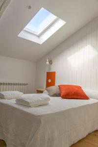 a bedroom with two beds and a skylight at Apartamento La Olmeda en ElMolinoDeLaSal de Sigüenza in Sigüenza