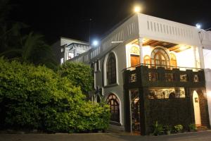a white building with a balcony at night at Fort de 19 Villa - Galle Fort in Galle