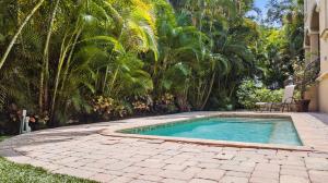 a swimming pool in a yard with palm trees at Siesta Key - Miramar 1216 in Siesta Key