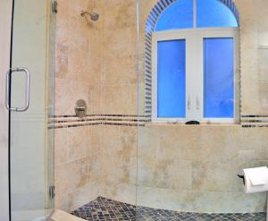 a bathroom with a shower with a window at Avenida De Cortez 5210 in Siesta Key