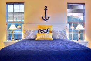 a bedroom with a bed with a blue comforter at Avenida De Cortez 5210 in Siesta Key