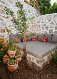 a bench in a garden with potted plants at Room in BB - Exclusive and Romantic Boutique Hotel in Fethiye