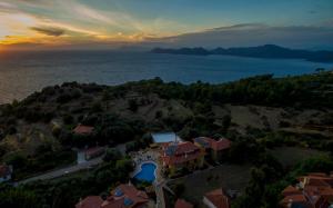 an aerial view of a house on a hill next to the water at Room in BB - Exclusive and Romantic Boutique Hotel in Fethiye
