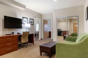 a hotel room with a desk and a television at Comfort Suites Marysville-Yuba City in Marysville