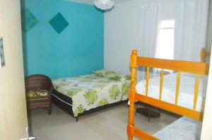 A bed or beds in a room at Hospedaria Solar De Morretes