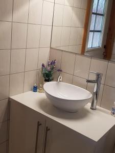 a bathroom with a white bowl sink on a counter at Gammelstuggu in Bjorli