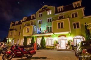 a hotel with a motorcycle parked in front of it at Hotel Sen in Świebodzin