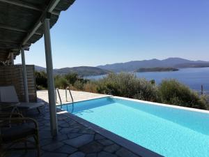 a swimming pool with a view of the water at Notus Villa in Chorto