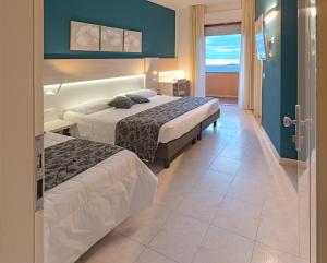 Posteľ alebo postele v izbe v ubytovaní Hotel il Delfino