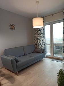 a living room with a couch and a large window at Apartament Września II in Września