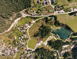 an aerial view of a village with a lake at Locanda Montana in San Vito di Cadore