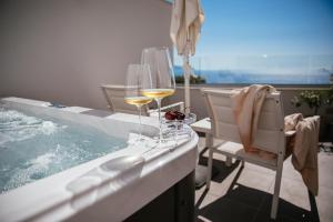 a bar with wine glasses and a swimming pool at Villa Fiorella Art Hotel in Massa Lubrense