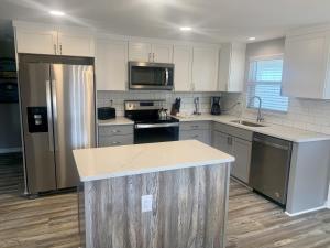 a kitchen with white cabinets and stainless steel appliances at Island House Beach Resort 24 in Siesta Key