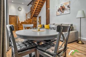 a dining room and living room with a table and chairs at Green Yard Villa in Predeal