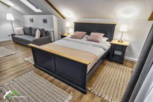 a bedroom with a large bed and a couch at Green Yard Villa in Predeal