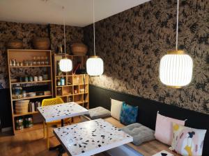 a dining room with two tables and two chairs at Rosie's Club in Ajaccio