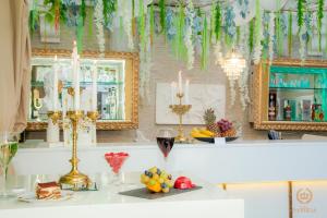 a room with a table with fruits and wine glasses at Hotel IMPERIA in Varna City