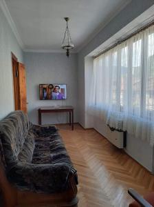 ein Wohnzimmer mit einem Sofa vor einem Fenster in der Unterkunft hotel in Chiatʼura