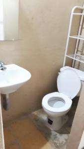 a bathroom with a toilet and a sink at Suite frente a la playa in Playas