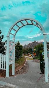 an arch over a walkway in a park at Rawaat Ghaym in Taif
