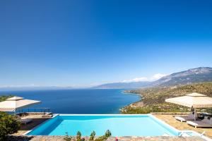 a swimming pool with a view of a body of water at Searocks Exclusive Village in Kalamata