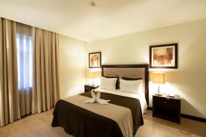 Postel nebo postele na pokoji v ubytování Veneza Hotel
