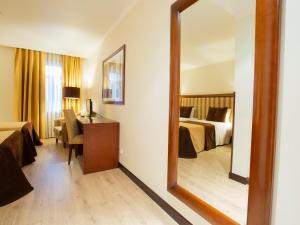 Postel nebo postele na pokoji v ubytování Veneza Hotel