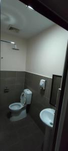 a bathroom with a toilet and a sink at Gorjes Inn KLIA & KLIA2 in Sepang