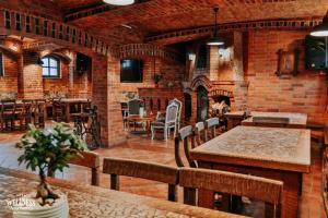 a room with a table and chairs and a brick wall at Wellness Apartment, Spa i Sauna in Mieszkowice