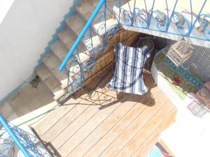 an overhead view of a staircase with a chair on a deck at Dar Warda in Bizerte
