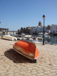 a boat sitting on the side of a harbor at Dar Warda in Bizerte