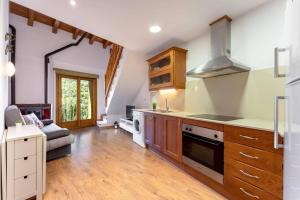 a kitchen with a stove top oven next to a couch at Apartamentsaloriaburg in Farrera