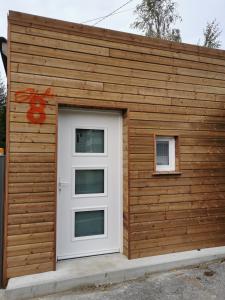 a building with a white door and two windows at Studio 8 in Sancourt