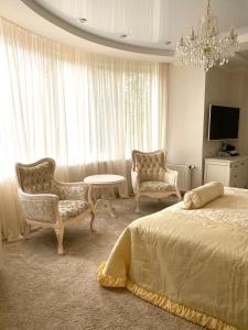 Postel nebo postele na pokoji v ubytování Sofievsky Posad Hotel