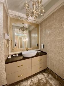 a bathroom with a sink and a large mirror at Sofievsky Posad Hotel in Kyiv