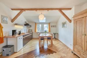 a kitchen with a wooden table in a room at Ferienwohnung Neukölln in Berlin