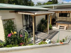 a screened in porch of a house with flowers at Union Street Hideaway in Waihi