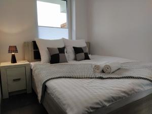 a bedroom with a large bed with two towels on it at Apartament 36 in Nowy Targ