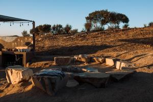 a group of rocks and benches in the dirt at UvaUva eco-retreat in Valle de Guadalupe