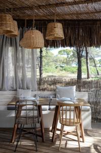 a dining room with a table and two chairs at Karidi Beach Boutique Suites in Vourvourou