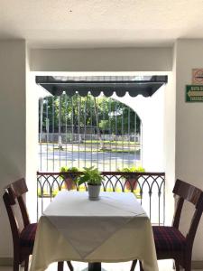 a table and two chairs with a view of a balcony at Hotel San Joaquin SA de CV in Colima