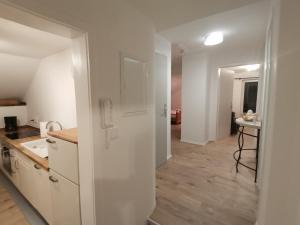 a kitchen with white cabinets and a table in a room at Ferienwohnung Bene in Oberau