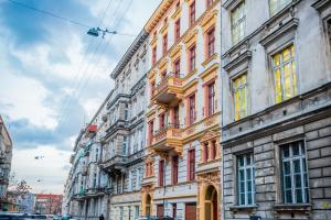 a row of tall buildings on a city street at Grey Rooms in Wrocław