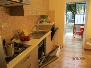 a kitchen with a sink and a stove top oven at RESORT Giardino degli aranci - Casa Lisca in Baronissi