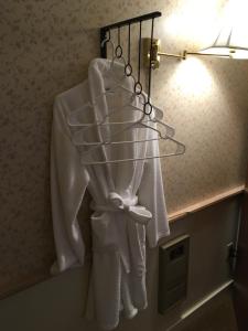 a rack with white towels hanging on a wall at Alexander's Lodge in Ashford