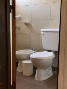 a bathroom with a toilet and a sink at Apart Hosteria Plaza- La Cumbre in La Cumbre +66 photos